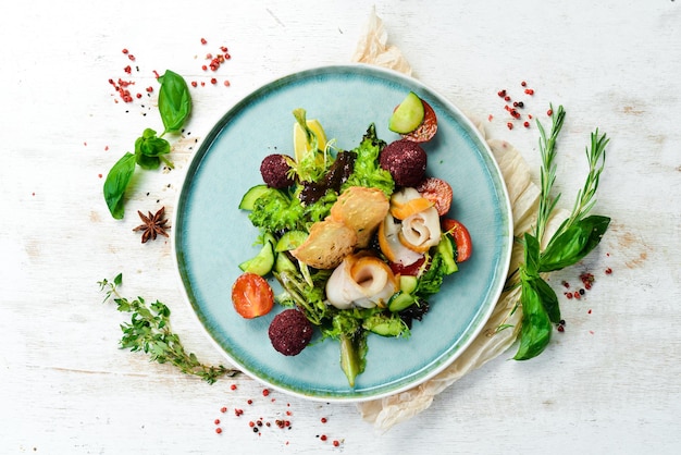 Salad with salted fish cheese and vegetables Top view Rustic style