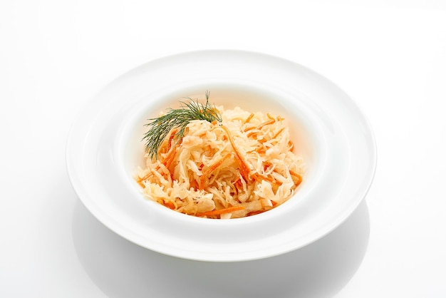 Salad with sauerkraut in a bowl on a white background