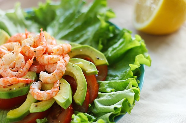 Salad with shrimp avocado and tomatoes Closeup