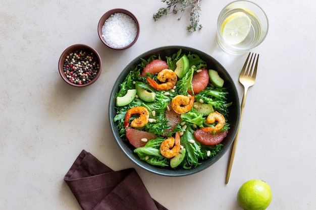 Salad with shrimp grapefruit avocado and nuts Healthy eating Diet