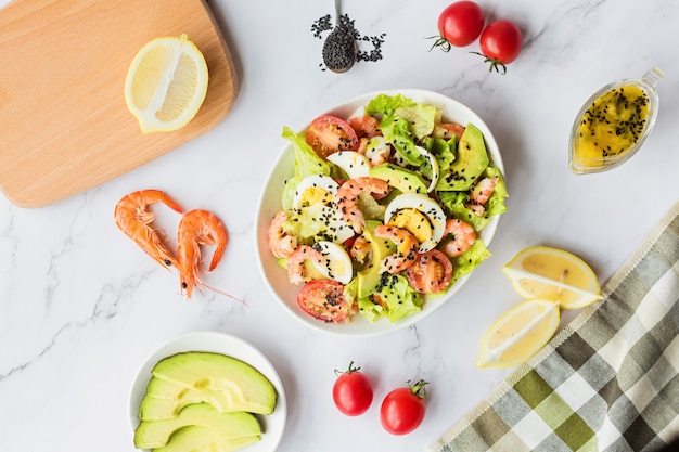 Salad with shrimps, lettuce, eggs, cherry tomatoes, chia seeds. 