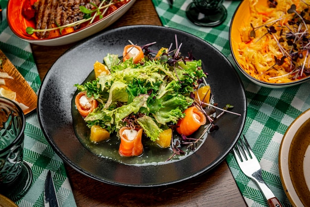 Salad with smoked salmon cream cheese and orange sauce