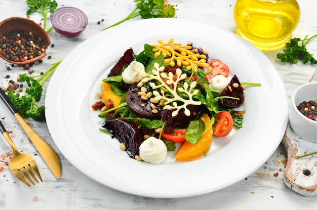 Salad with spinach, beets and vegetables. Cold snacks. Rustic style.