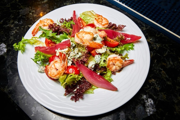 Salad with tiger shrimp pear and greens