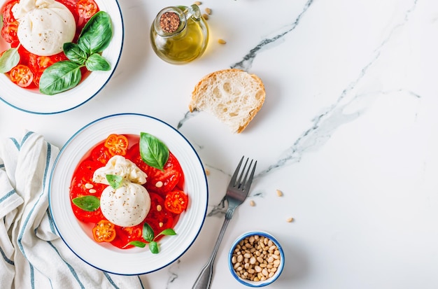 Salad with Tomato Burrata cheese with basil and olive oil