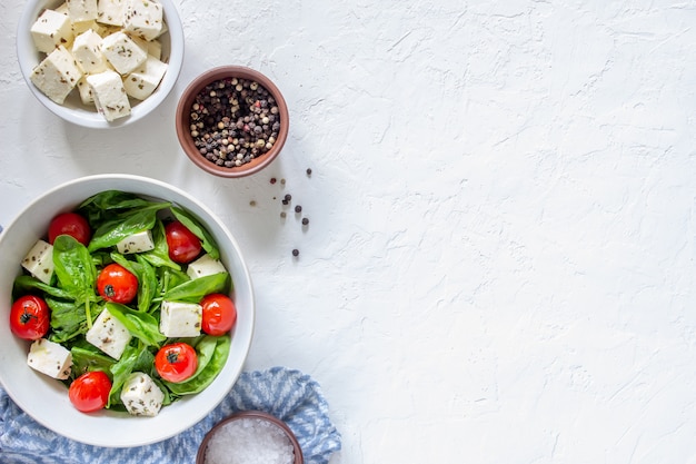 Salad with tomatoes, spinach and cheese.