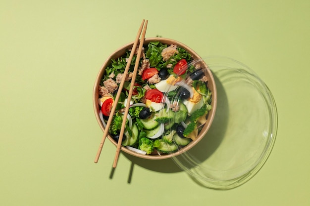 Salad with tuna on a green background