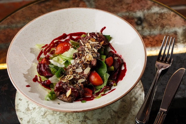 Salad with veal and tomatoes Beef steak with raw vegetables mix side view Grilled meat with garnish closeup Delicious main course on table