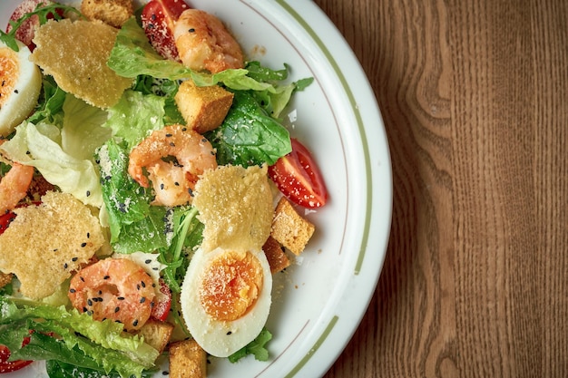 Salad with vegetables tuna and boiled egg Nicoise salad Wooden background