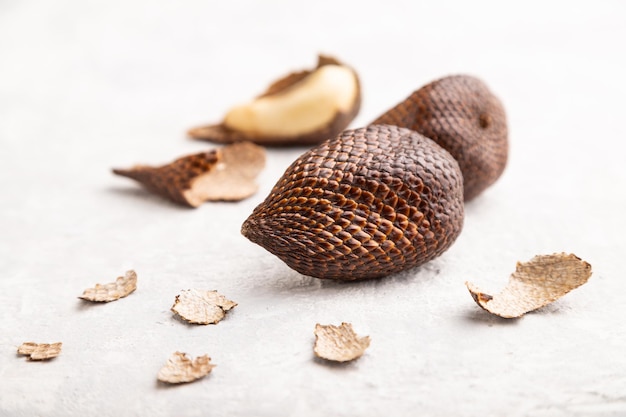 Salak or snake fruit on gray concrete background Side view close up selective focus