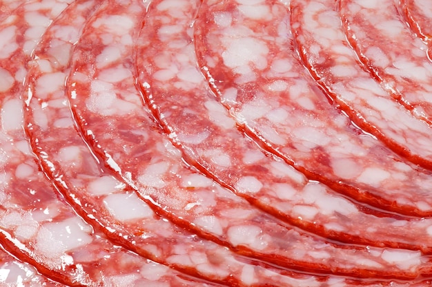 Salami sausage meat with bacon cut into circles closeup