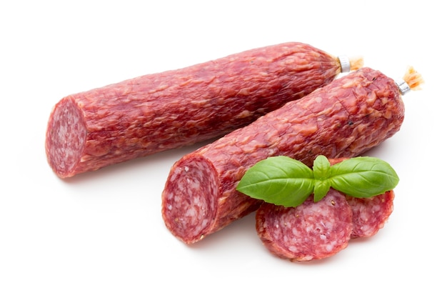 Salami smoked sausage, basil leaves and peppercorns isolated