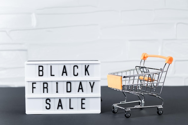 Sale and Black Friday concept Mini shopping cart on white background