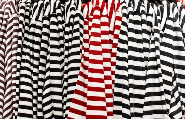 Sale of clothing in the store Texture of striped Tshirts with red and black stripes