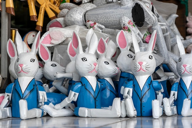 Sale of souvenirs funny handmade wooden hares in street market Bright colorful children toys and decoration for interior Ubud Bali island Indonesia Close up