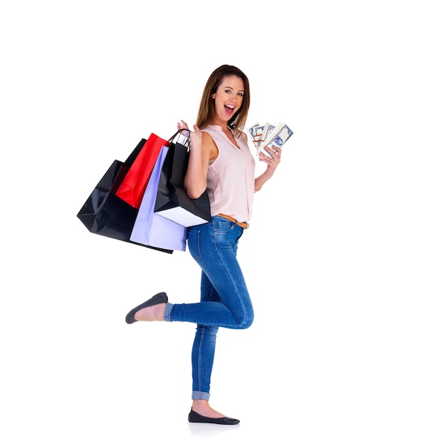 On to the next sale Studio shot of a young woman with money to spend