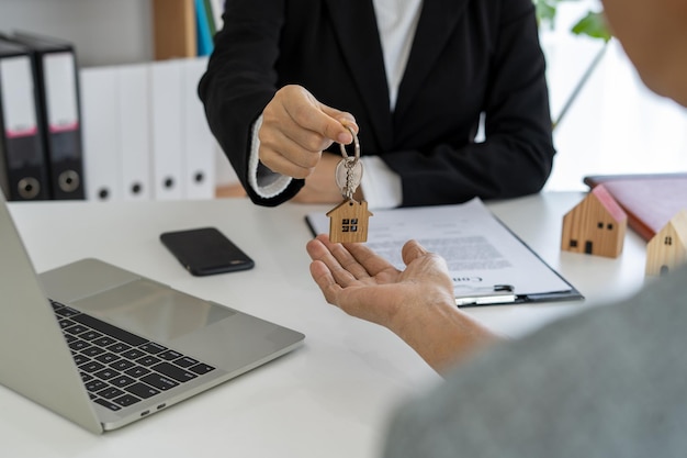 Sales agents are sending home keys to customers after discussing contracts to buy a home insurance or real estate loan