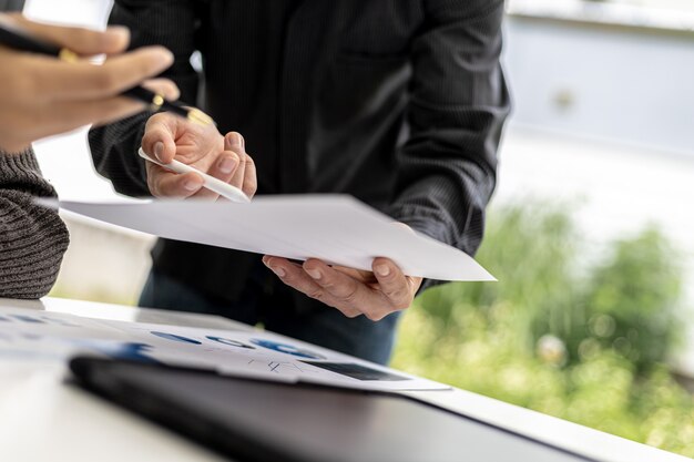 The sales department is having a monthly summary meeting to bring it to the department manager, they are verifying the correctness of the documents that are prepared before bringing in to the manager