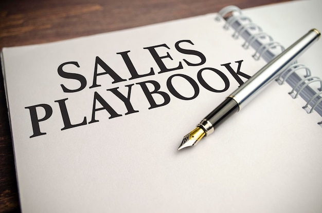 Sales playbook words with pen and paper