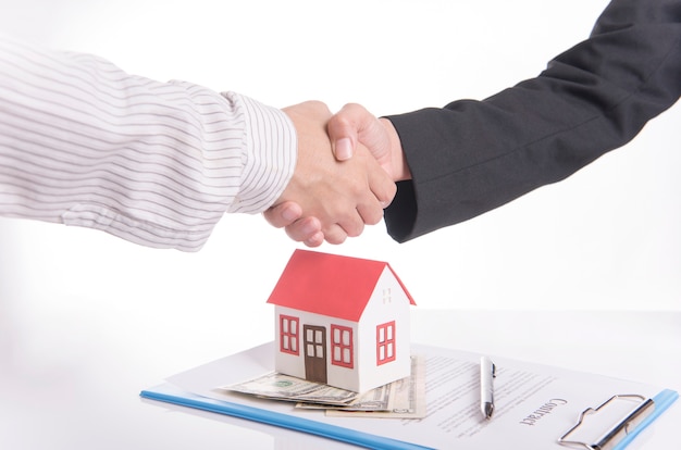 salesman agent handshake with customer after agreement contract sale home.