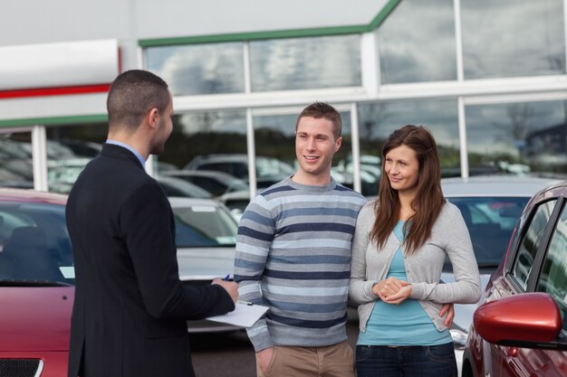 Salesman talking to a couple