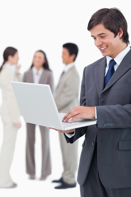 Salesman with notebook and team behind him