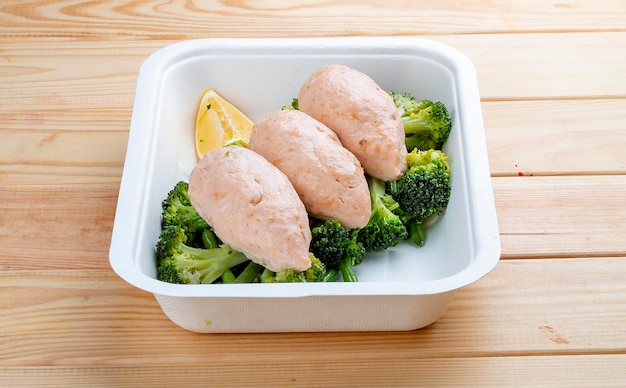 Salmon cutlets with broccoli and green beans Healthy food Takeaway food On a wooden background