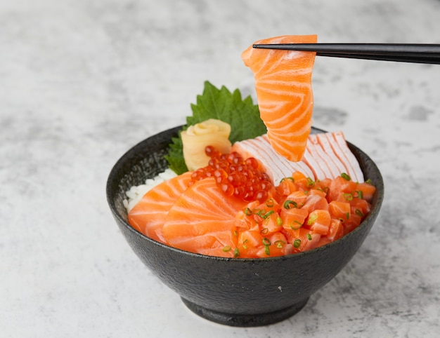 Salmon donburi japanese rice bowl food with raw salmon ikura and fresh fish