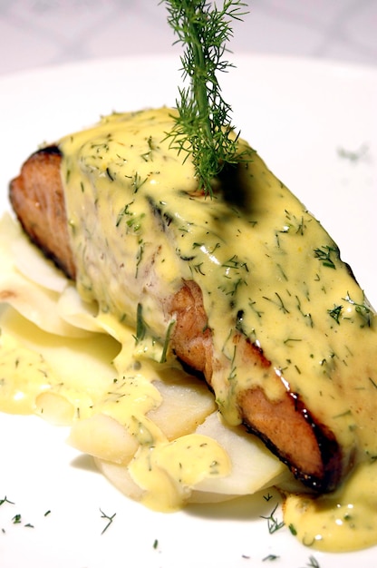 Salmon fillet covered in mustard sauce with potatoes food