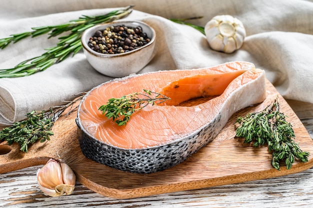 Salmon fillet steak on a chopping Board. Raw Organic fish 