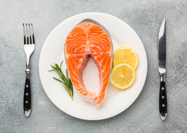 Salmon and lemon on plate flat lay