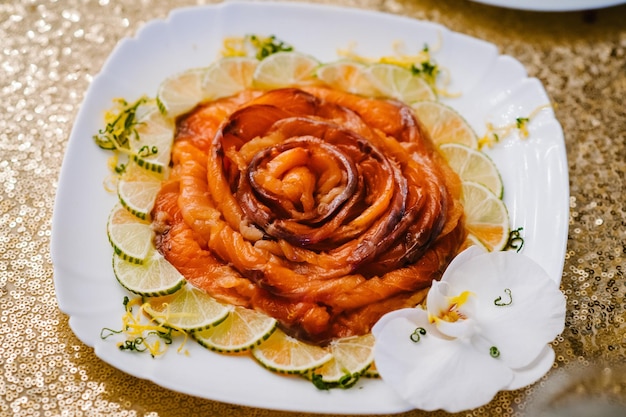 Salmon raw Slice of salmon red fish with lemon isolated on a white plate