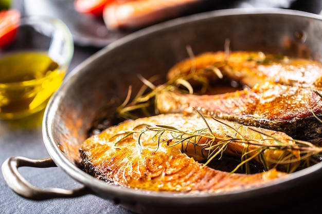 Salmon roasted steaks rosemary sal pepper olive oil - Close-up.