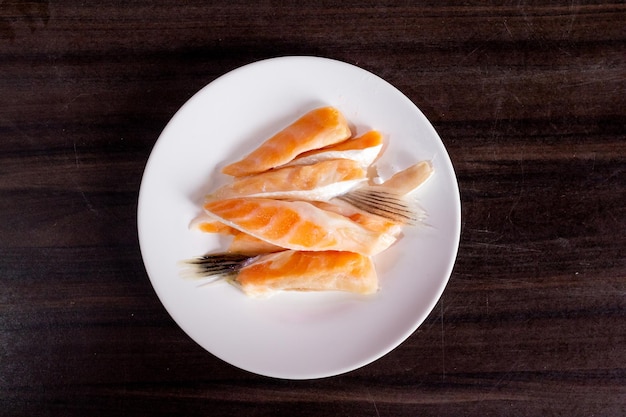 Salmon slices on white plate