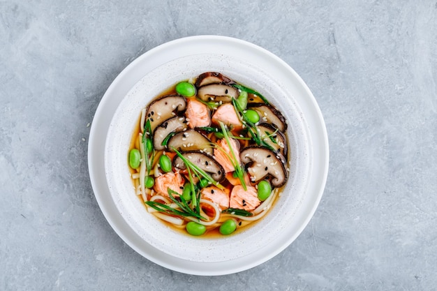 Salmon and soba broth Salmon Noodle Soup with shiitake mushrooms edamame beans and green onion