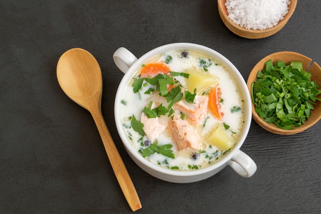 Salmon soup with cream, potatoes, carrots and dill.