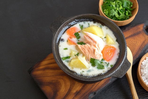 Salmon soup with cream, potatoes, carrots and dill.