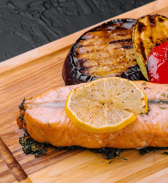 Salmon steak on the grill with grilled vegetables