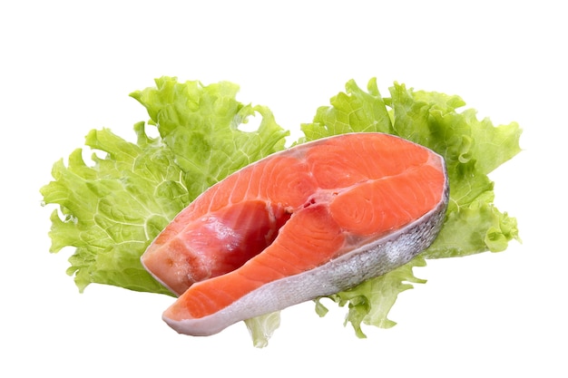 Salmon steak on lettuce leaves isolated on white background