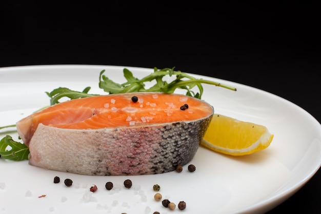 Salmon steak with black pepper lemon and herbs