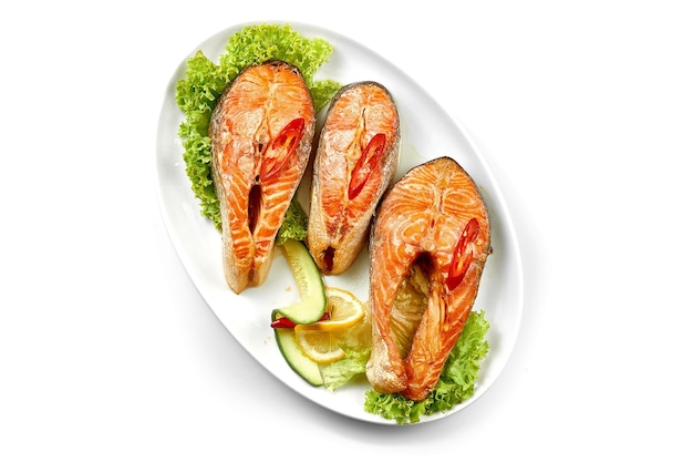 Salmon steaks in a white plate on a white background Closeup selective focus