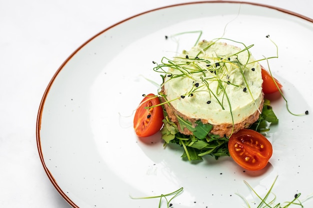 Salmon tartar Raw salmon avocado purple onion salad delicious avocado served with arugula Restaurant menu dieting cookbook recipe top view