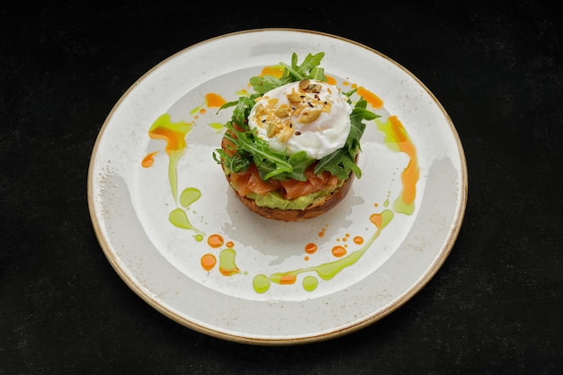 Salmon tartar with avocado poached egg and arugula