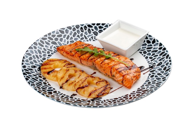 Salmon with cream sauce and grilled pineapple On a white background