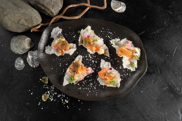 Salmon with radish in honey ponzu on rice chips