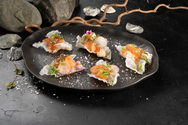 Salmon with radish in honey ponzu on rice chips