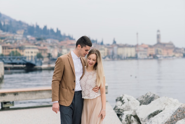 Salo, Italy . Romantic young couple  walking on the lake bank, tenderness