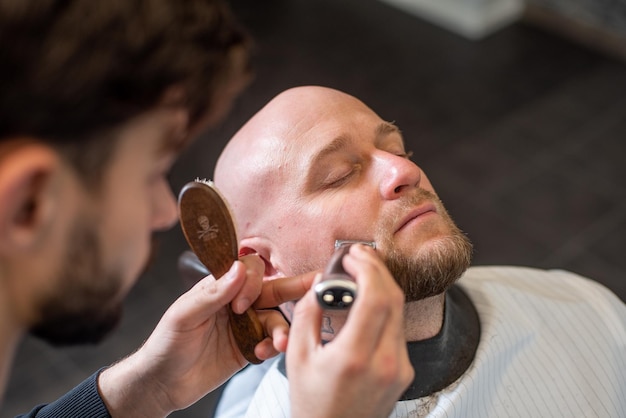 Salon Brutal man sitting in a barber chair