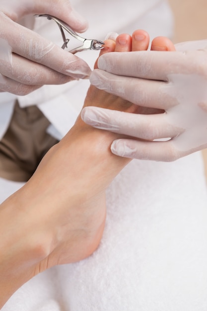 Salon worker using a nail clippers