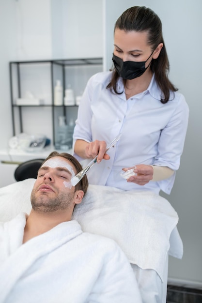 In the salon. Young man having procedures in the cosmetological salon